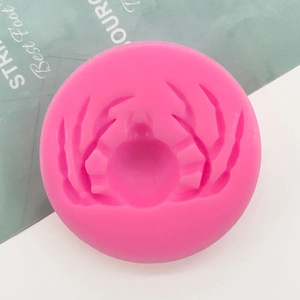 Macro detail of round pink silicone mold featuring symmetrical wing-shaped grooves for DIY