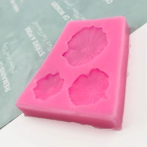 Pink silicone mold featuring three distinct lotus leaf shapes for soap and fondant making