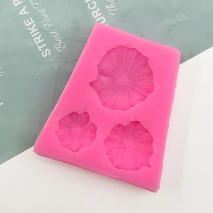 Detailed macro view of pink silicone mold with three different sized lotus leaf patterns