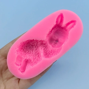 Pink silicone mold featuring a sleeping baby bunny for cake decorating and DIY soap making