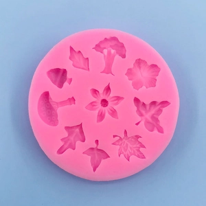 Pink silicone mold with flower, mushroom, and leaf shapes for fondant and cake decor