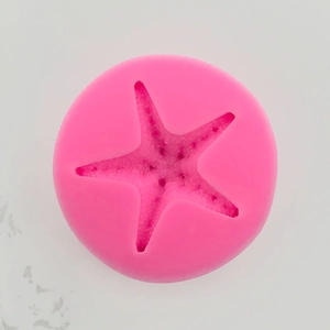 Close-up of pink round silicone starfish mold for chocolate and fondant cake decorating