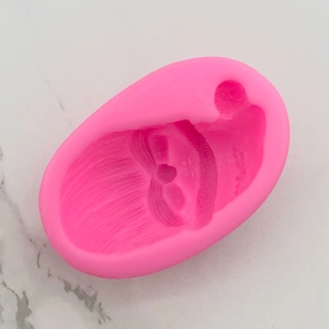 Detailed relief of Santa Claus inside a pink silicone mold for cake and fondant decoration