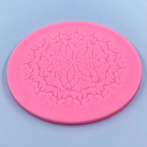 Pink circular silicone mold with detailed mandala flower pattern for cake decorating