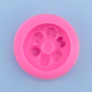 Detailed macro view of pink silicone mold featuring Hello Kitty and bow patterns