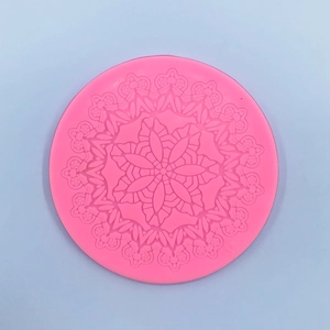 Macro detail of pink round silicone mold featuring intricate mandala floral lace pattern