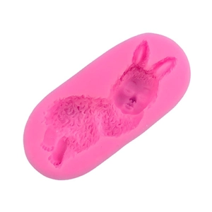 Pink silicone mold featuring a sleeping baby in a bunny suit for baking and DIY crafts