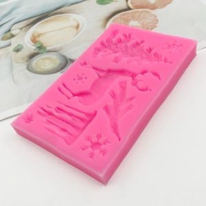 Pink silicone Christmas mold with snowflake and tree shapes for DIY baking crafts