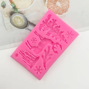 Close-up of pink silicone Christmas mold with reindeer and snowflake patterns