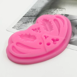Pink silicone mold with holly leaf and berry patterns for DIY cake decoration
