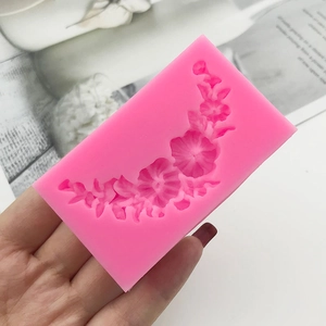 Pink silicone mold with curved floral wreath pattern for DIY fondant cake decoration