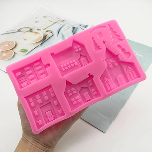 Pink silicone mold for castle and house shapes, ideal for fondant and chocolate crafts