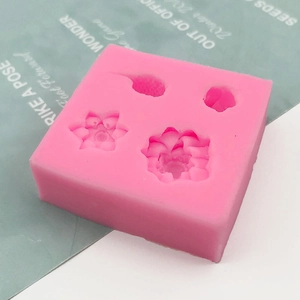 Pink silicone mold featuring detailed 3D lotus and carp shapes for DIY cake or resin crafts