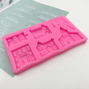 Pink silicone mold featuring multiple castle and house shapes for cake and DIY crafts