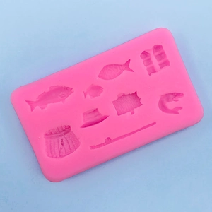 Detailed view of pink silicone mold with fishing rod, vest, and fish shapes for baking
