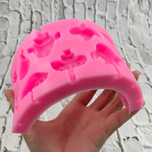 Pink silicone vehicle mold for DIY candies featuring car, plane and boat shapes