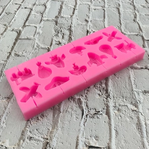 Pink silicone mold with 12 transport shapes for DIY chocolate and candy baking