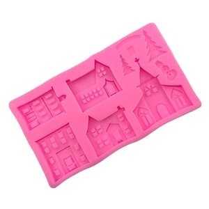 Pink silicone mold featuring miniature winter town houses, Christmas trees and a snowman