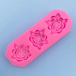 Detail of 3-cavity pink silicone mold featuring intricate 3D rose flower patterns