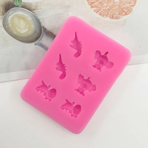 Detail of pink silicone mold with six cartoon elephant and dinosaur shapes for DIY baking