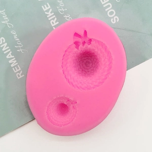 Detailed close-up of pink silicone 3D bow straw hat molds for fondant and cake decorating