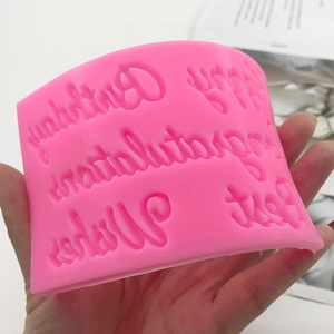 Pink silicone mold featuring Happy Birthday and Congratulations lettering for DIY cake decor