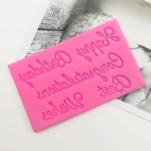 Close-up of pink silicone mold with Happy Birthday and Best Wishes lettering