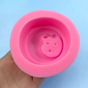 Pink silicone mold featuring sleeping baby on moon and stars for DIY handmade soap and plaster