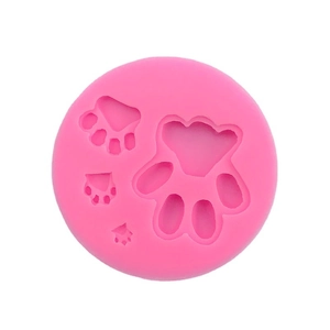 Pink silicone dog paw print mold for DIY baking and chocolate making on white background