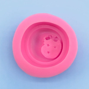 Top macro view of a pink silicone mold with star and moon patterns for DIY soap making