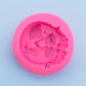 Macro shot of rose pink silicone mold featuring intricate figure and flower relief