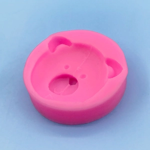 Pink bear silicone mold for fondant, chocolate and resin crafting on blue background