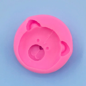 Detailed top view of pink silicone round mold with cute bear face for baking and DIY craft
