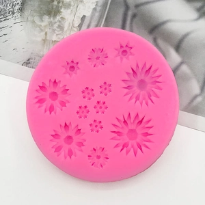 Macro view of a pink silicone daisy mold with multiple sizes for fondant and chocolate