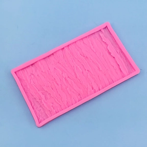Detailed macro view of pink silicone mold featuring a realistic tree bark and rock texture