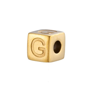 Detail of 14K gold plated stainless steel cube bead featuring engraved letter G