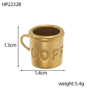 Detailed view of tiny golden metal coffee cup pendant with engraved text and dimensions