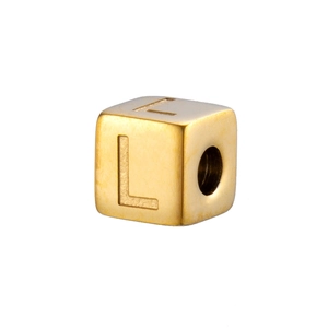 Macro detail of cube bead with engraved letter L and hole for DIY jewelry making