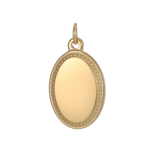 Close-up of a golden oval pendant with a polished surface and a delicate beaded edge