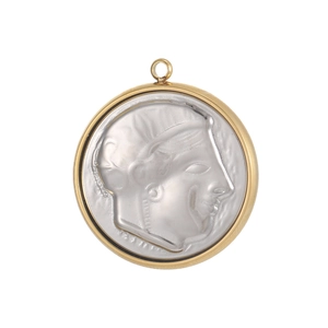 Macro shot of vintage round stainless steel pendant featuring an embossed portrait relief