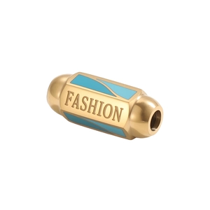 Macro detail of gold stainless steel cylinder charm with blue enamel and FASHION engraving