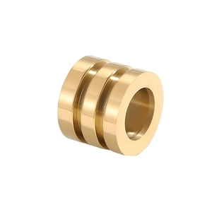 Macro detail of high-polish gold stainless steel triple-layered spacer bead for DIY jewelry
