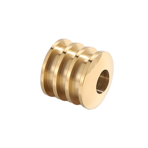 Detailed macro view of a polished gold cylindrical bead with four parallel grooves