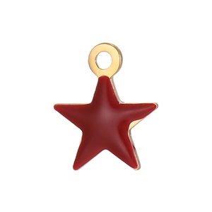 Macro shot of a red enamel star pendant with a gold metal border for DIY jewelry making
