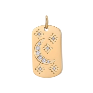 Detailed macro view of gold plated rectangular pendant with crescent moon and star patterns