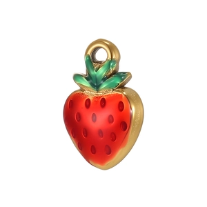 Macro shot of red strawberry pendant charm with green leaf detail and gold plating
