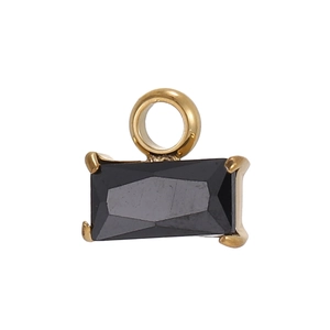 Macro detail of rectangular black gemstone pendant with golden four-claw setting