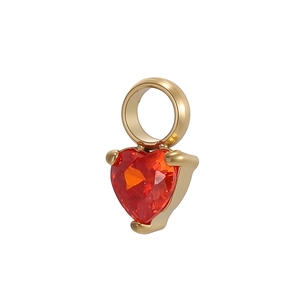 Macro view of a heart-shaped orange zircon pendant with polished gold-plated base