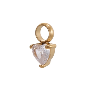 Macro view of a gold heart pendant featuring a clear cubic zirconia stone and thick bail