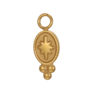 Détail macro du pendentif ovale en or avec motif d'étoile gravé et bordure perlée vintage